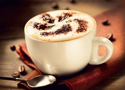 Cappuccino sprinkled with chocolate powder.