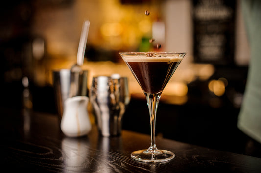 A picture of Moonwalk Coffee Martini in a martini glass garnished with three coffee beans.